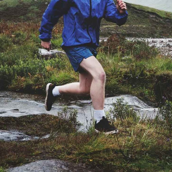 Runner crossing a stream
